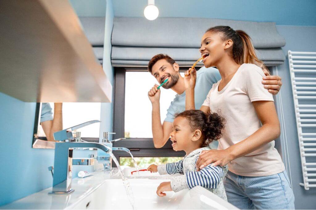 A happy family engaged in toothbrushing.