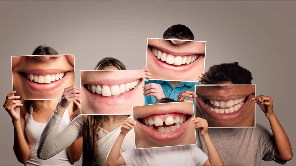 Group of people holding up pictures of different smiles